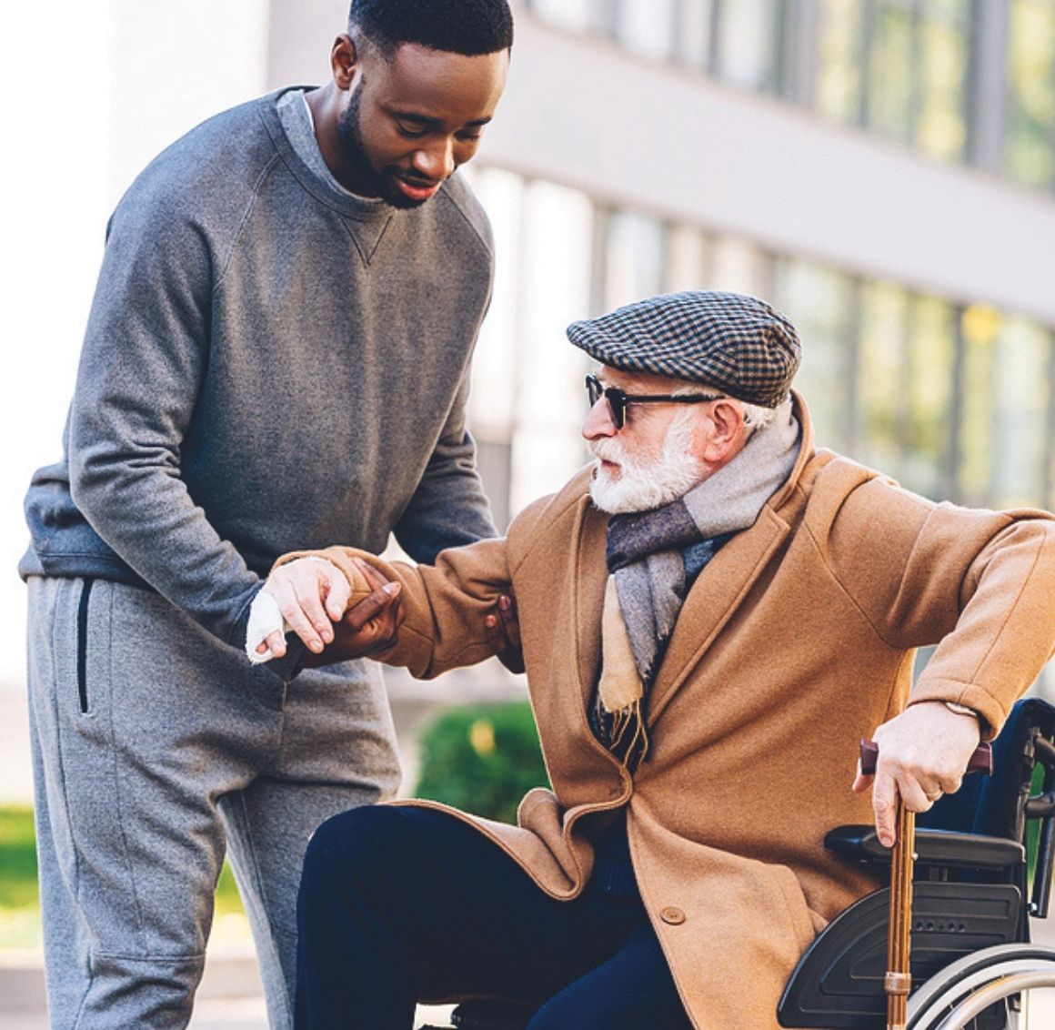 Caregiver providing respectful personal-care assistance to an elderly woman while preserving dignity.
